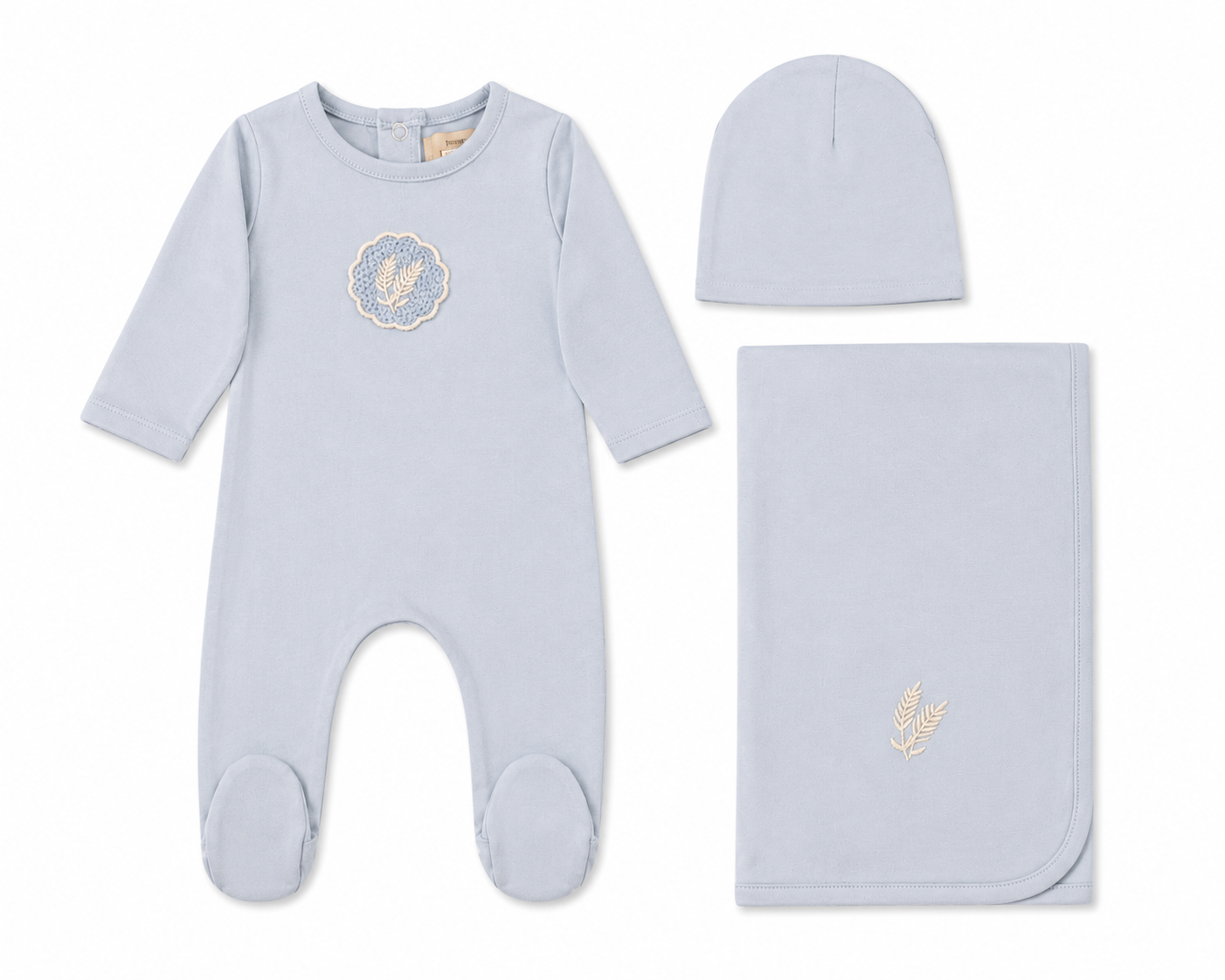 White cotton baby layette set with crochet appliqué detail and bonnet