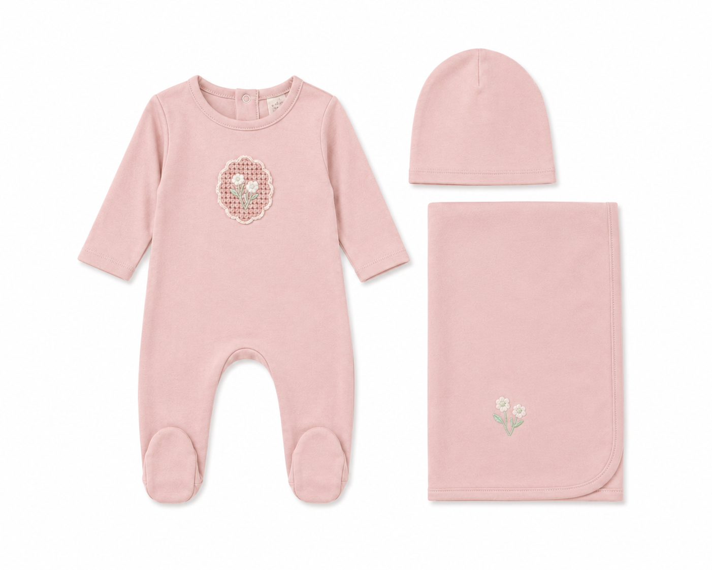 White cotton baby layette set with crochet appliqué detail and bonnet